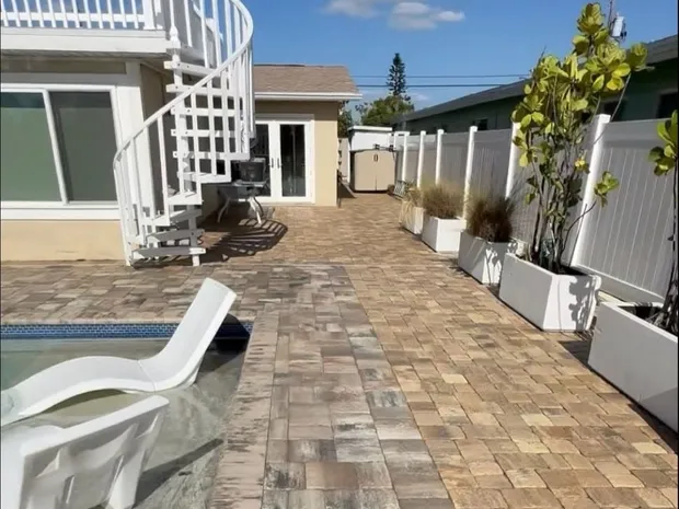 The same pool deck after cleaning, joint sanding and sealing, with the paver color restored