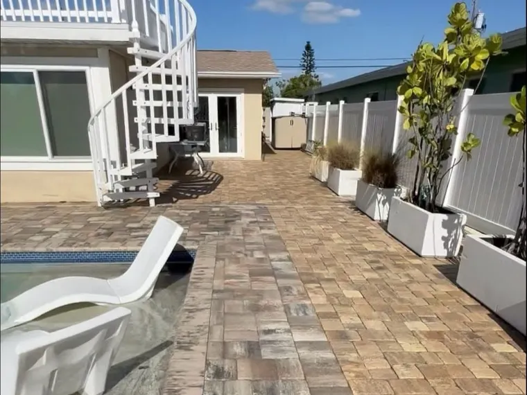 The same pool deck after cleaning, joint sanding and sealing, with the paver color restored